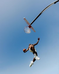 a basketball player dunks the ball in the air